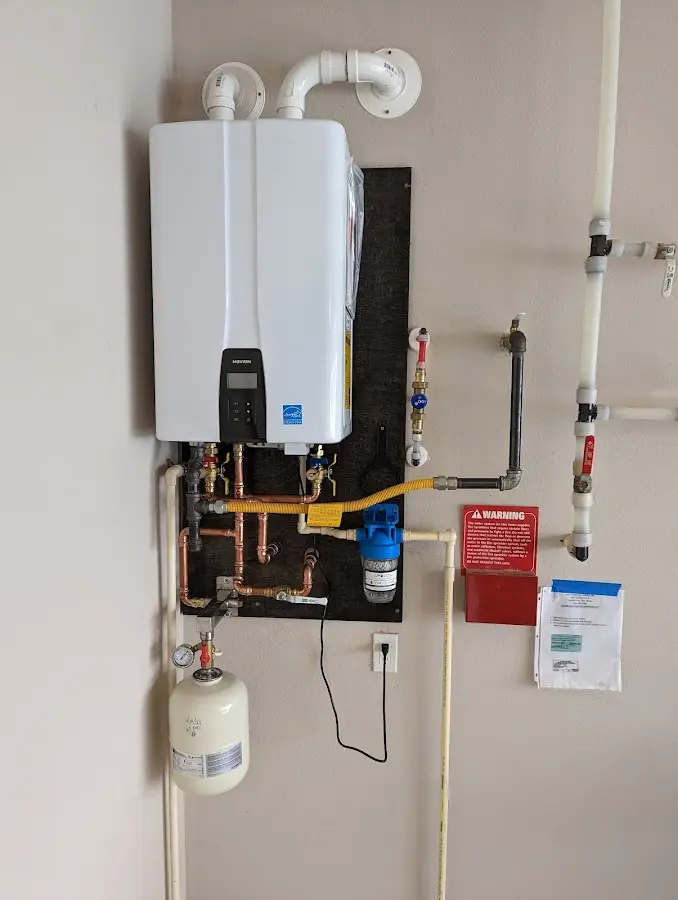 Professional plumber installing copper piping in a O'Neill home